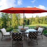 A 13ft Orange Red Umbrella on a deck.