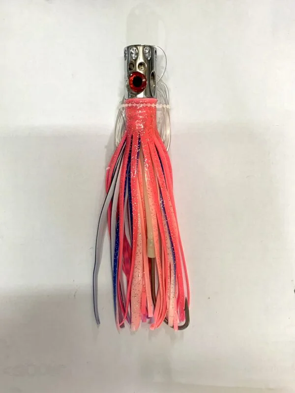 A pink and blue tee shaped lure on a white surface.