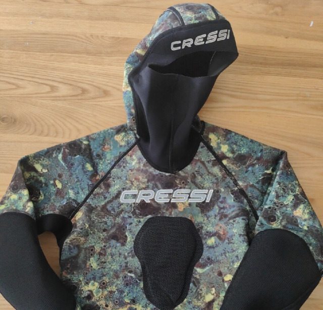 A cresso full body suit kept on a wooden table