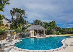 A home with a large swimming pool constructed by professional pool builders.